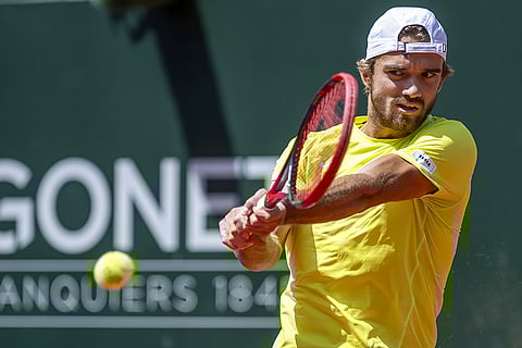 Tomas Machac returns a ball to Novak Djokovic